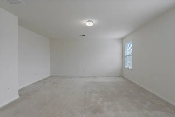 an empty room with a empty space and window