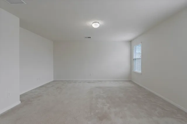 an empty room with a empty space and window