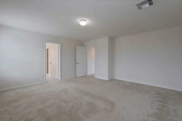 a view of an empty room and a bathroom