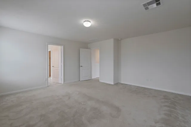 a view of an empty room and a bathroom