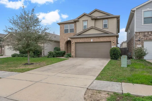 a front view of a house with a yard and garage