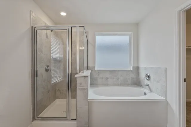 a bathroom with a bathtub and a shower