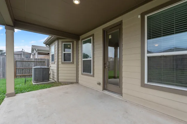 a view of a house with backyard and porch