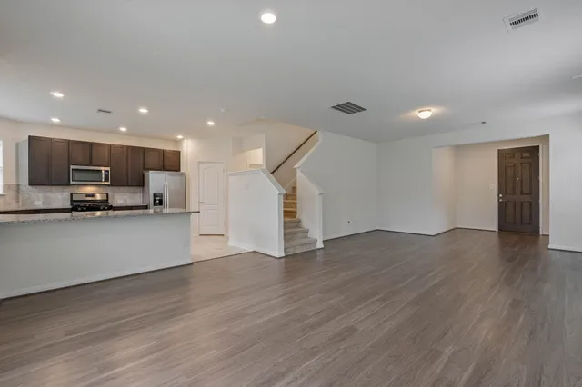 a view of kitchen with refrigerator and window