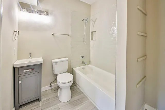 a bathroom with a toilet sink and shower