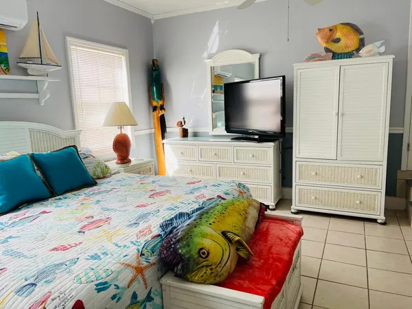 a bedroom with a bed and flat screen tv