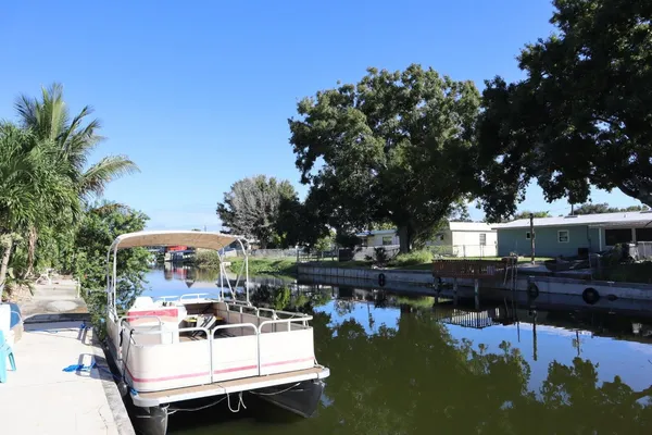 a view of a house with lake view and wooden floor