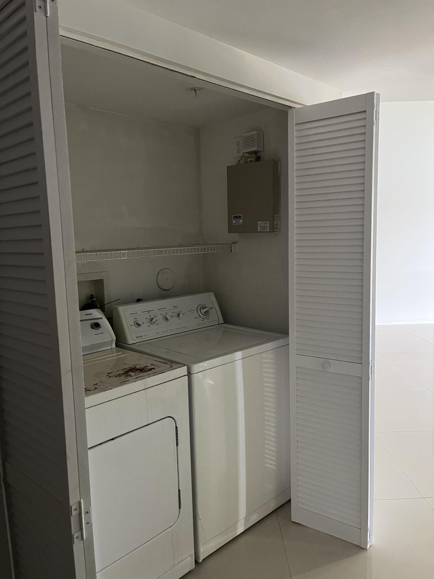 4191 Haverhill Road, Unit 409 West Palm Beach, FL 33417 - Photo 14 of 17 a utility room with dryer and washer