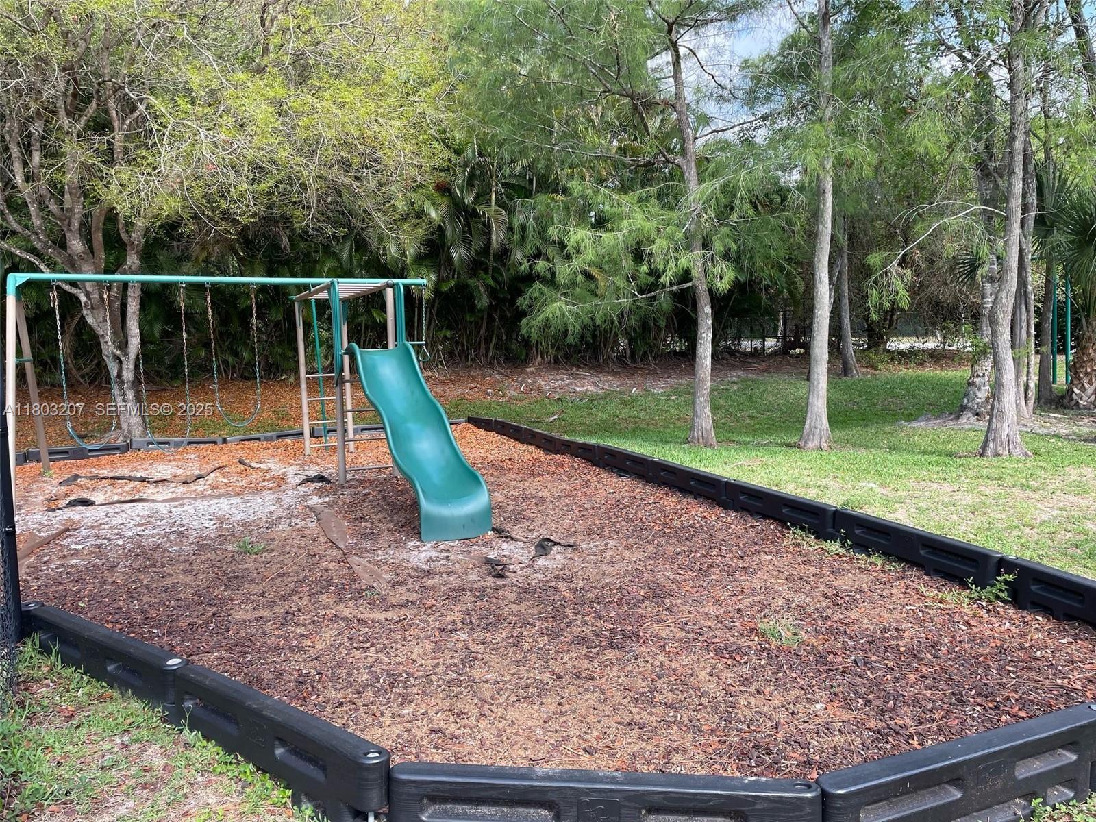 4191 Haverhill Road, Unit 409 West Palm Beach, FL 33417 - Photo 15 of 17 a view of a park with swings