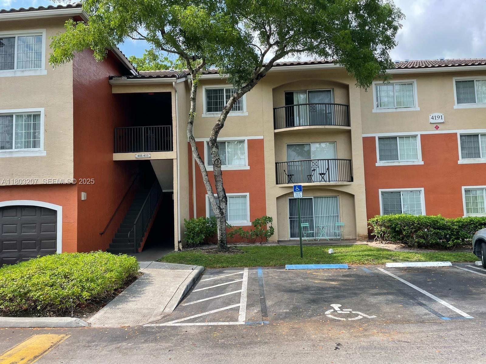4191 Haverhill Road, Unit 409 West Palm Beach, FL 33417 - Photo 2 of 17 a front view of a house with a garden