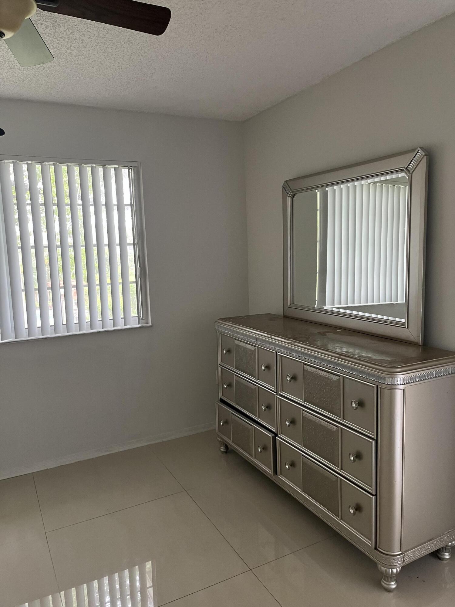 4191 Haverhill Road, Unit 409 West Palm Beach, FL 33417 - Photo 8 of 17 a room with cabinets and a window