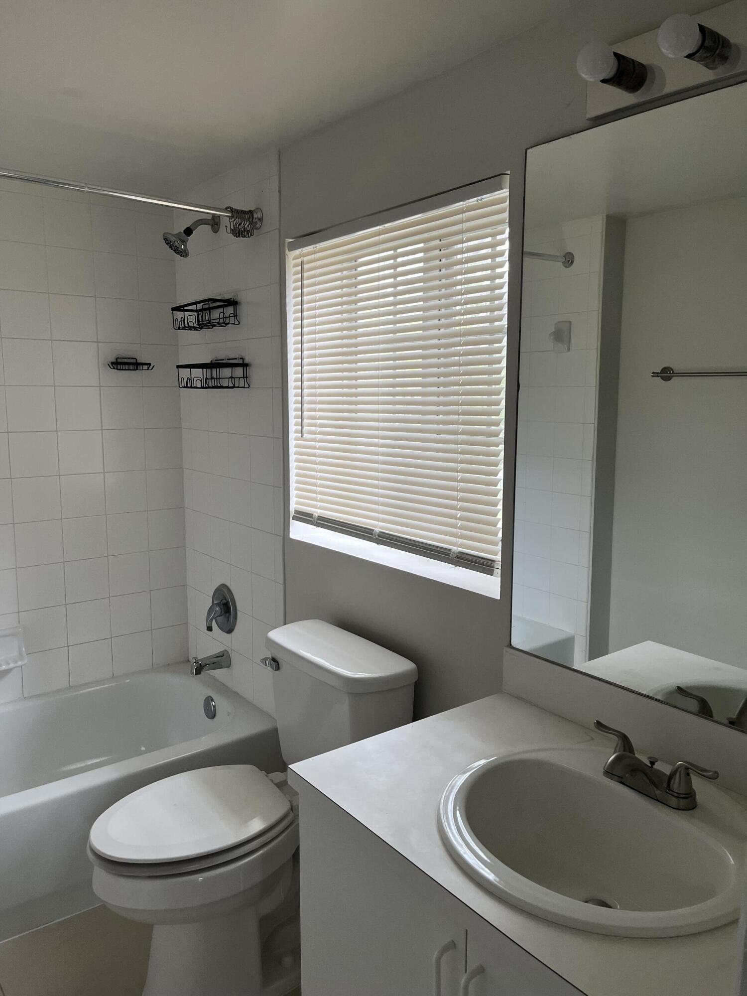 4191 Haverhill Road, Unit 409 West Palm Beach, FL 33417 - Photo 9 of 17 a bathroom with a sink and a toilet