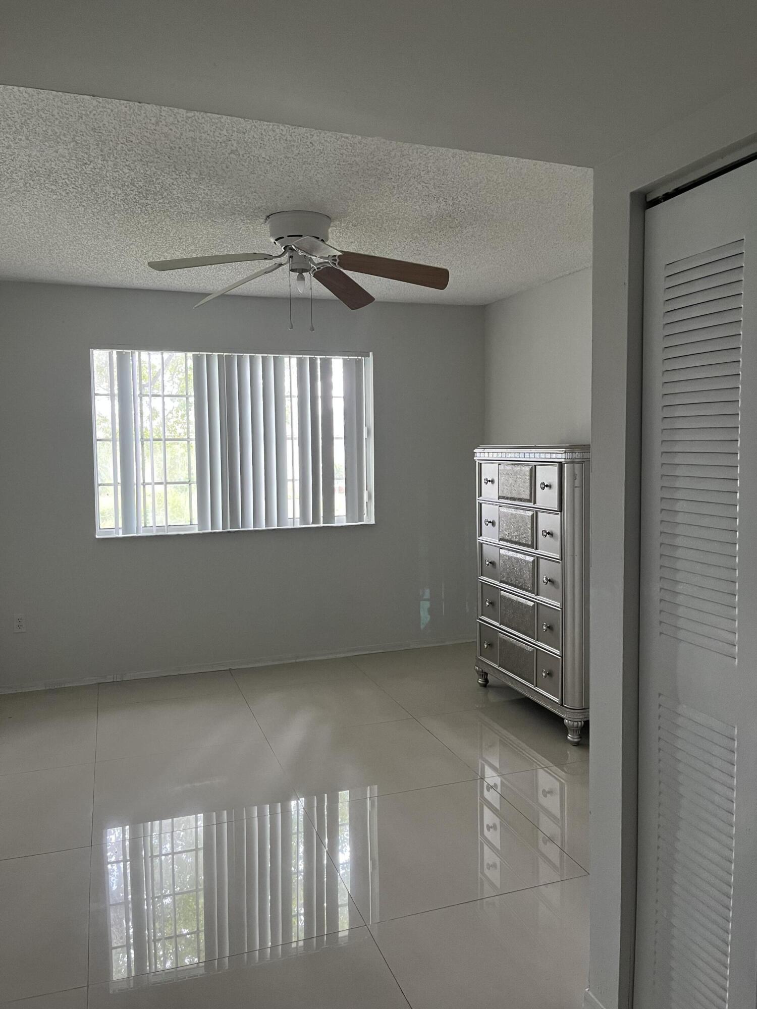 4191 Haverhill Road, Unit 409 West Palm Beach, FL 33417 - Photo 10 of 17 a view of an empty room with a window