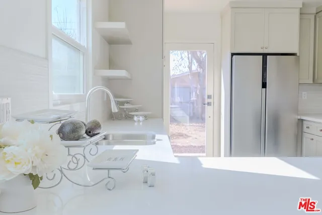 a bathroom with a sink mirror and shower
