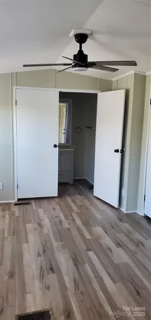 a view of a big room with wooden floor and cabinet