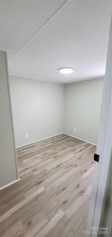 an empty room with wooden floor