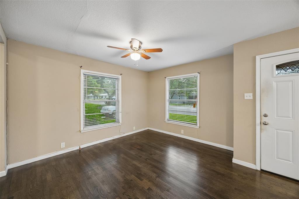 117 Moon Street Cleburne, TX 76033 - Photo 4 of 28 a view of an empty room with a window and wooden floor