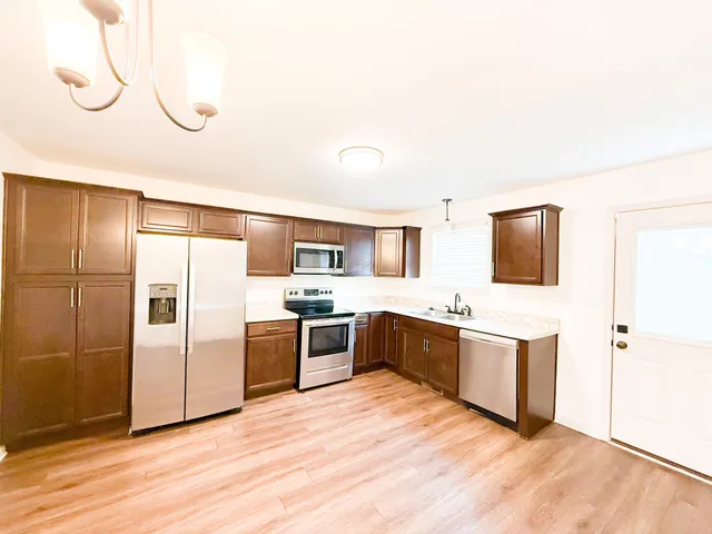 a large kitchen with cabinets and stainless steel appliances