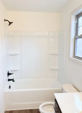 a bathroom with a bathtub and a toilet