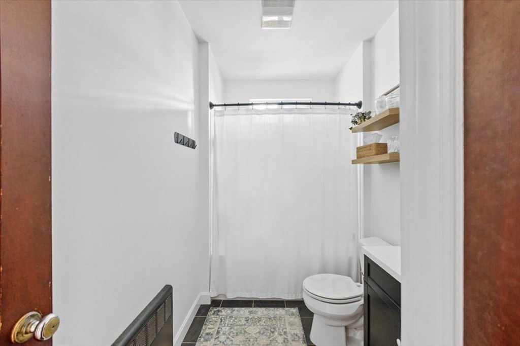 68 Congress Street Fall River, MA 02721 - Photo 9 of 38 a bathroom with a granite countertop toilet and a sink