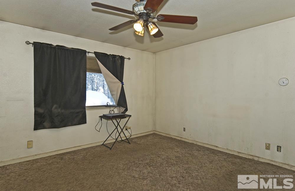 166 Pleasant Valley Road Markleeville, CA 96120 - Photo 13 of 24 an empty room with windows and chandelier fan