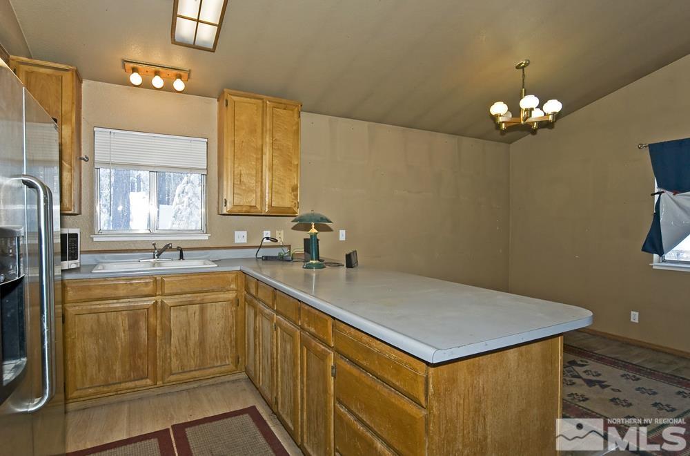 166 Pleasant Valley Road Markleeville, CA 96120 - Photo 9 of 24 a kitchen with a stove a sink and a refrigerator
