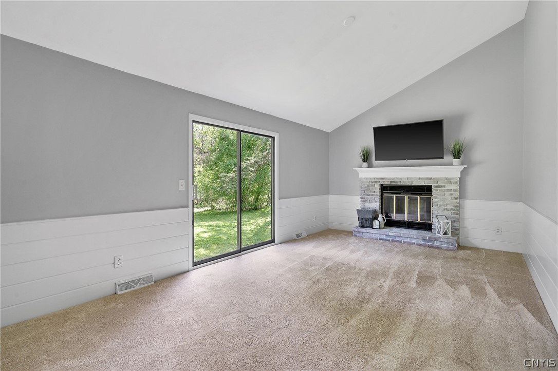 8841 Wandering Way Lysander, NY 13027 - Photo 19 of 42 Family room boasts a cozy wood burning fireplace to keep you toasty on those cool nights.