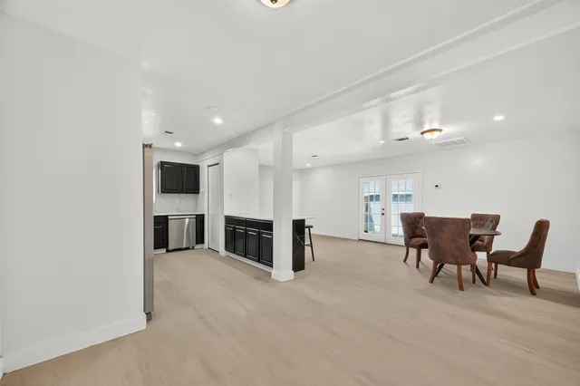 a view of a kitchen with furniture and wooden floor