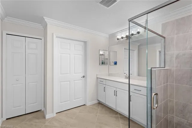 a spacious bathroom with a shower sink and mirror