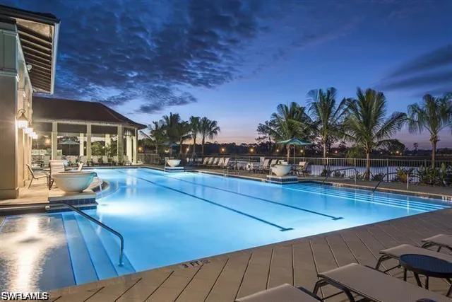 a view of a swimming pool with an outdoor seating