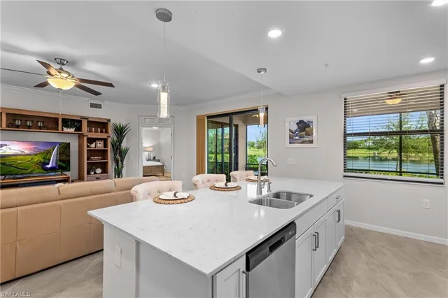 a living room with furniture a flat screen tv and a large window