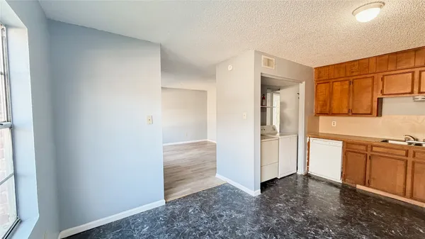 a view of kitchen with refrigerator and window
