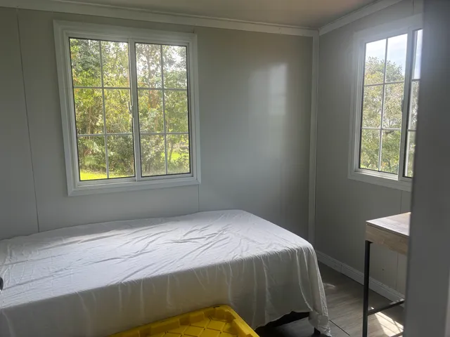 a bedroom with a bed and a window