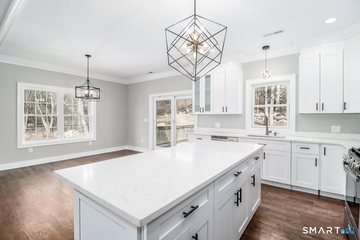 53 Pembroke Road Danbury, CT 06811 - Photo 16 of 37 a kitchen that has a lot of white cabinets and wooden floor