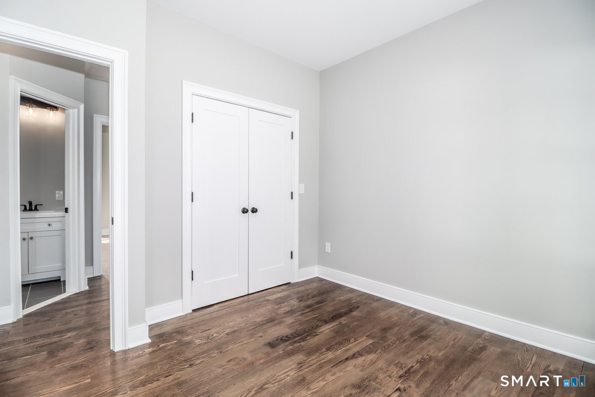 53 Pembroke Road Danbury, CT 06811 - Photo 22 of 37 an empty room with wooden floor and closet