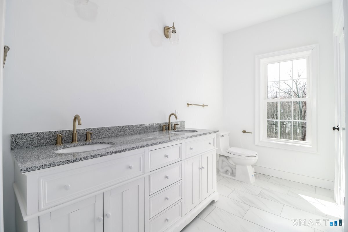 53 Pembroke Road Danbury, CT 06811 - Photo 28 of 37 a bathroom with a granite countertop sink and a toilet