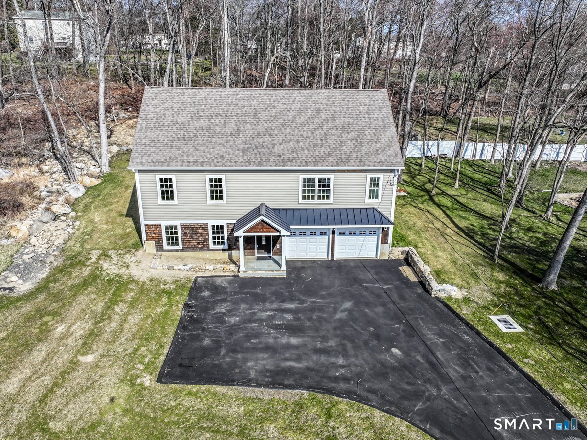 53 Pembroke Road Danbury, CT 06811 - Photo 3 of 37 a house with tall trees in front of it