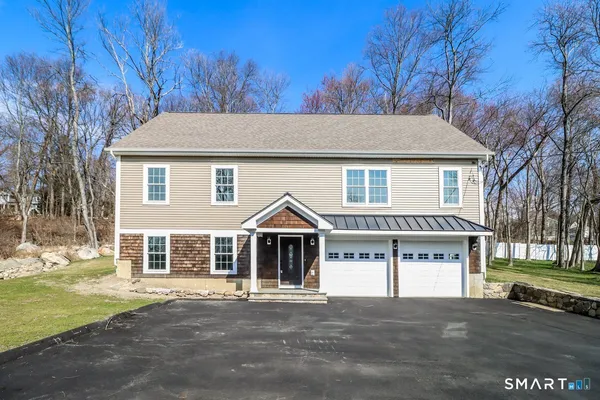 a view of a house with a yard and garage
