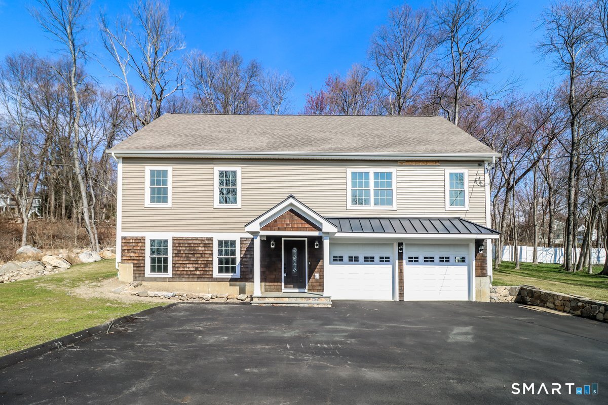 53 Pembroke Road Danbury, CT 06811 - Photo 32 of 37 a view of a house with a yard and garage