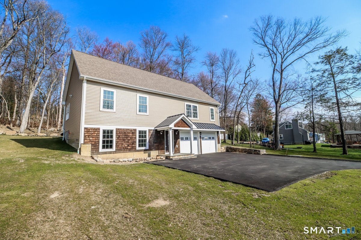 53 Pembroke Road Danbury, CT 06811 - Photo 34 of 37 a front view of a house with a garden