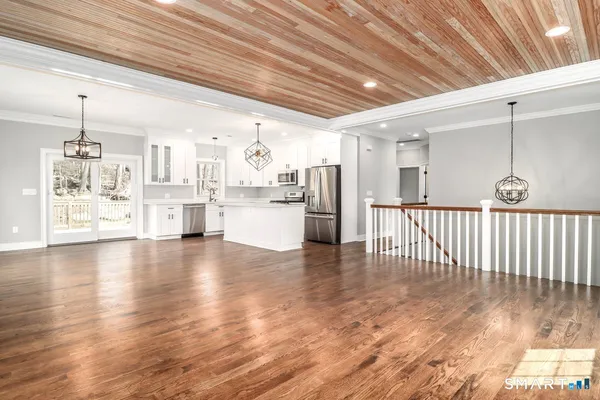 a view of a kitchen with furniture and wooden floor
