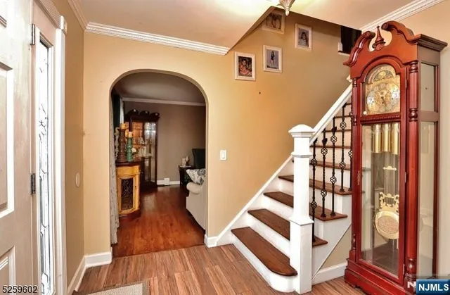 a view of staircase with wooden floor and a large window