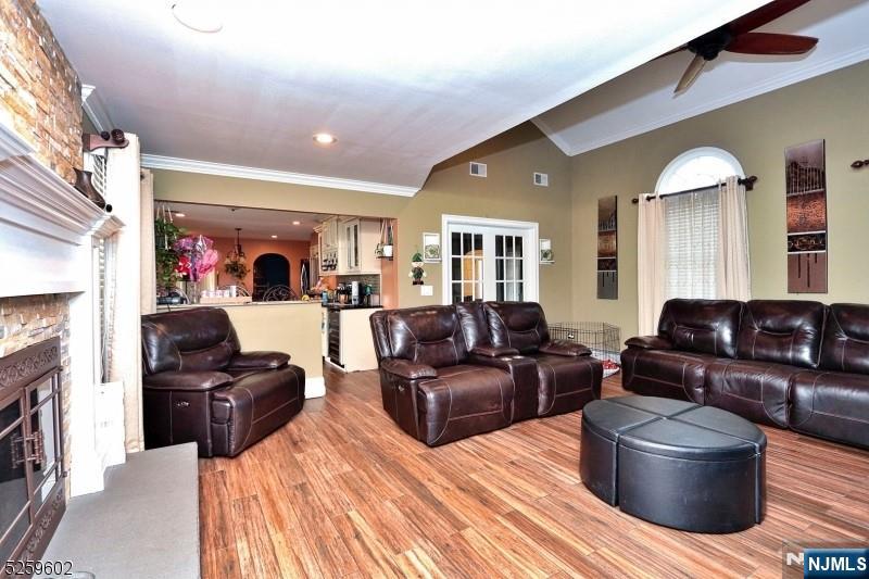 8 Winfield Court Fairfield, NJ 07004 - Photo 7 of 16 a living room with furniture and a fireplace