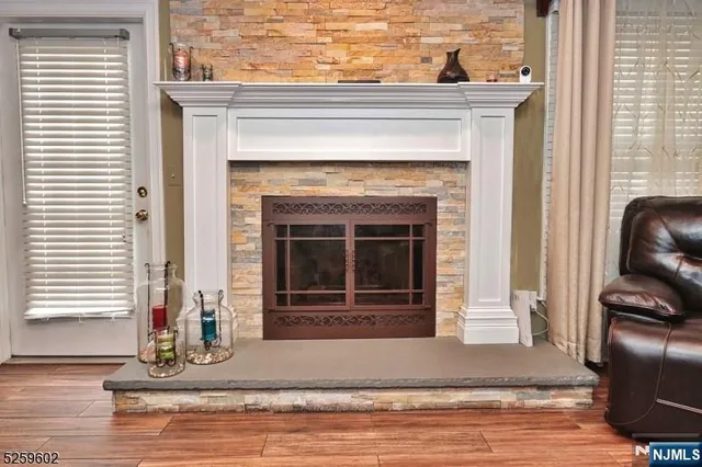 a living room with a fireplace and wooden floor