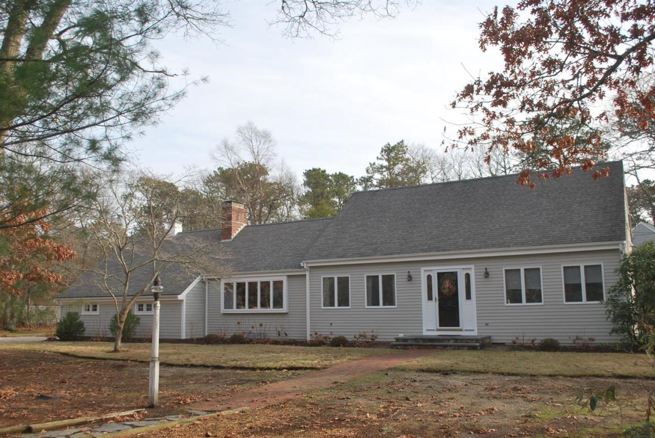 11 Cotuit Cove Road Cotuit, MA 02635 - Photo 1 of 35 a house that has a tree in front of it