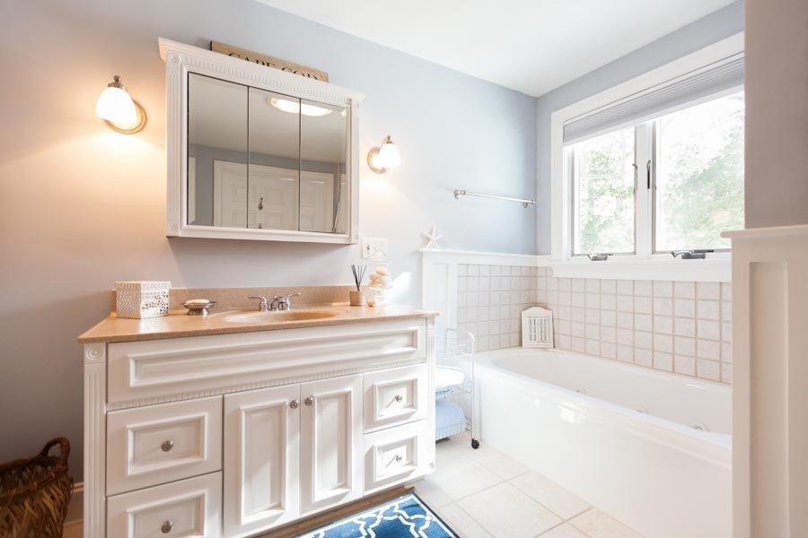 11 Cotuit Cove Road Cotuit, MA 02635 - Photo 14 of 35 a bathroom with a sink a bathtub and a vanity