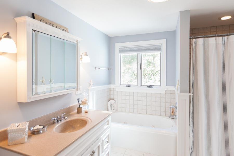 11 Cotuit Cove Road Cotuit, MA 02635 - Photo 15 of 35 a bathroom with a sink vanity tub and a mirror