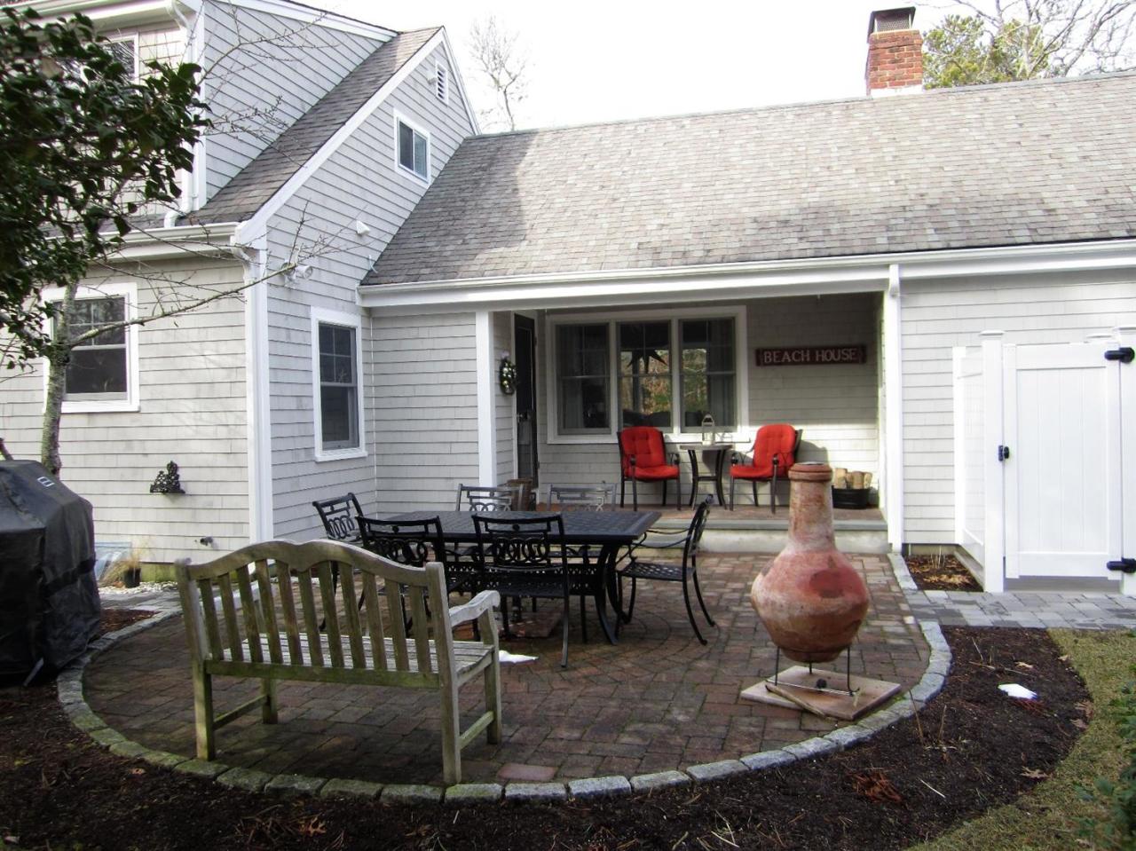 11 Cotuit Cove Road Cotuit, MA 02635 - Photo 29 of 35 a view of a patio with table and chairs