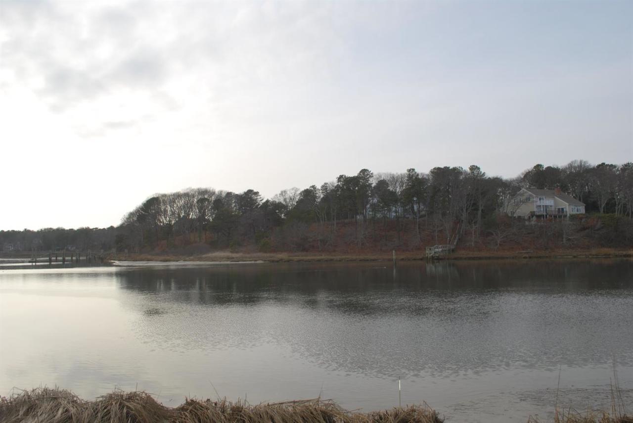 11 Cotuit Cove Road Cotuit, MA 02635 - Photo 33 of 35 a view of a lake with a city