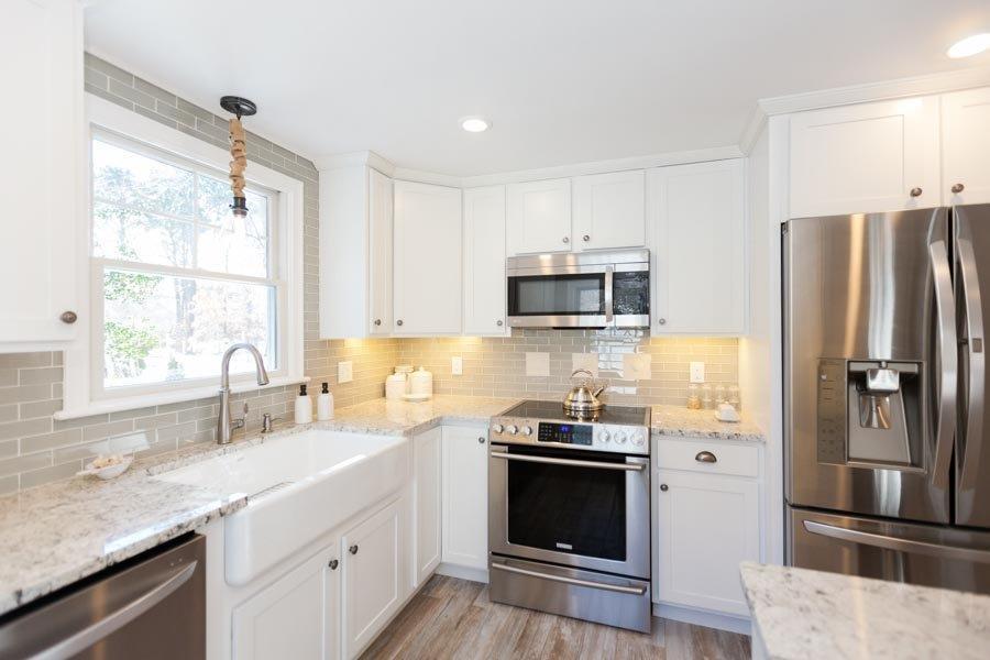 11 Cotuit Cove Road Cotuit, MA 02635 - Photo 10 of 35 a kitchen with stainless steel appliances a refrigerator sink and microwave